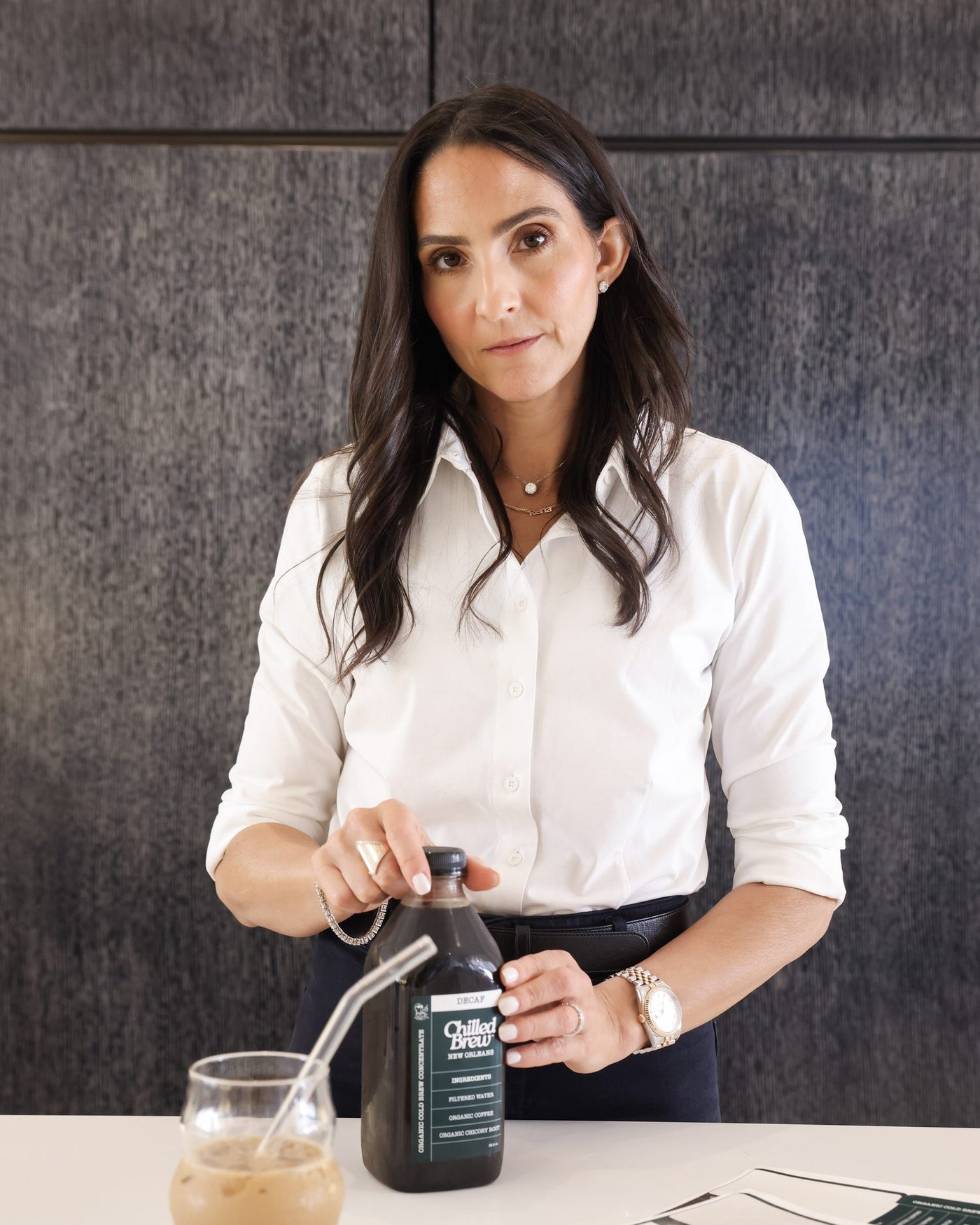 Gail Farca, founder of Chilled Brew, opening a bottle of New Orleans Decaf